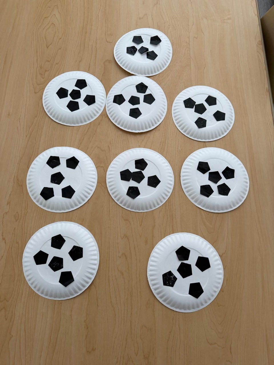 Paper-plate crafts laid out to dry.