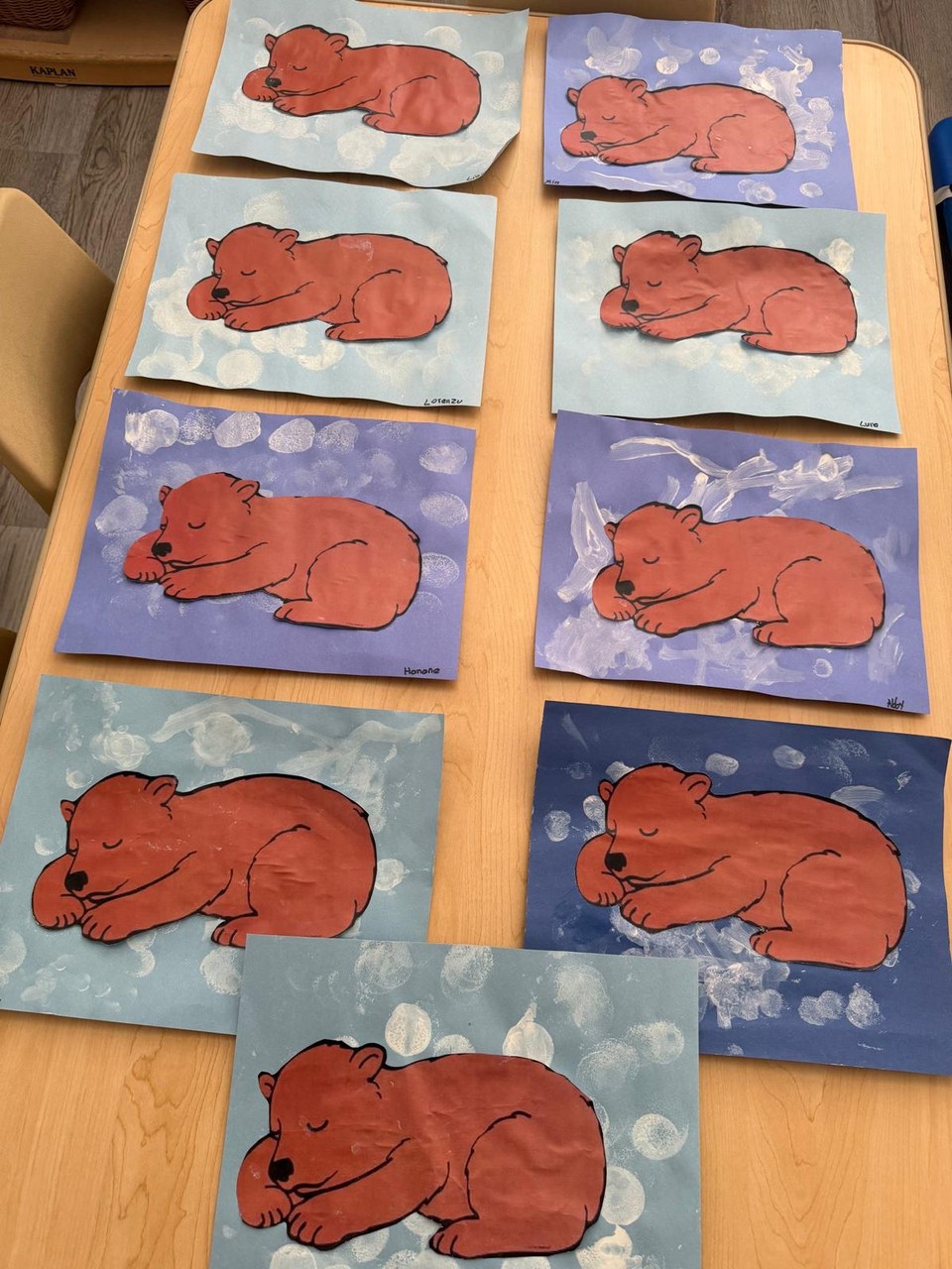 Children's paintings of sleeping bears, ready for the hallway display.